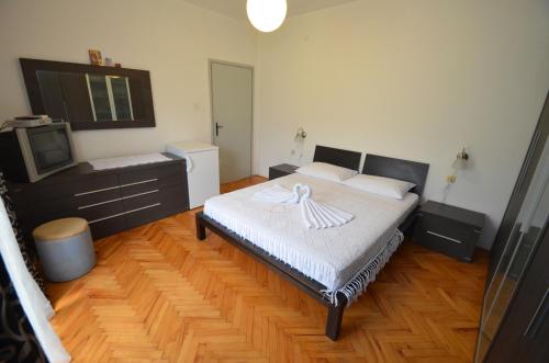 a bedroom with a bed and a tv in it at Apartments Ivetić in Kotor