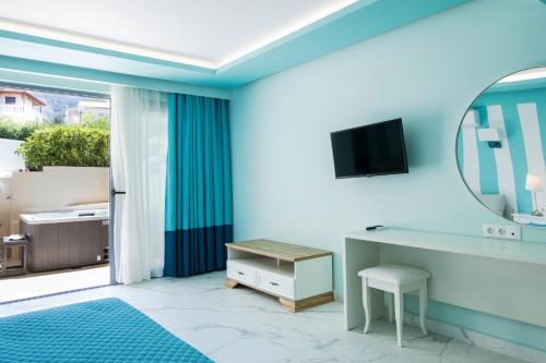 a bathroom with a mirror and a dressing table and a mirror at Agios Gordios Beach Resort in Agios Gordios