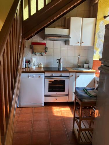 a kitchen with a white stove and a sink at Casa Rural Amamana in Jemein