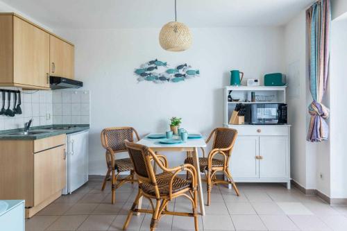 a kitchen with a table and chairs in a room at Haus Seeblick Wohnung 11 "Blåkulle" in Wohlenberg