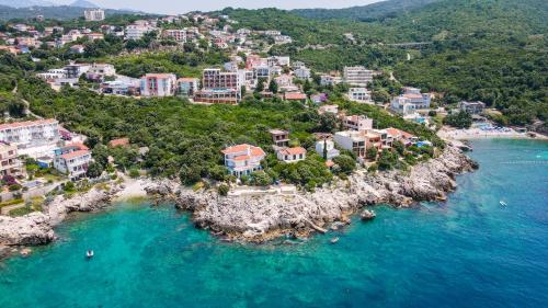 an aerial view of a resort on a rocky island in the water at Bungalovi Arabela in Utjeha