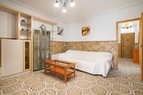 a bedroom with a bed and a table at Geranio in Caserío Bacarot