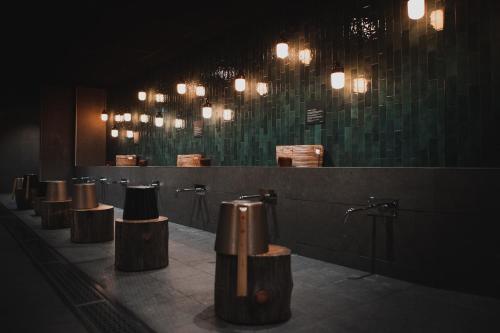 a row of stalls in a public restroom with lights at Hotell Lappland in Lycksele