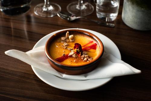 a bowl of soup on a plate on a table at Hotell Lappland in Lycksele