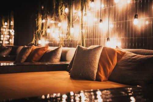 a row of pillows on a couch in a room with lights at Hotell Lappland in Lycksele