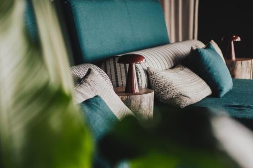 a living room with a couch with blue pillows at Hotell Lappland in Lycksele