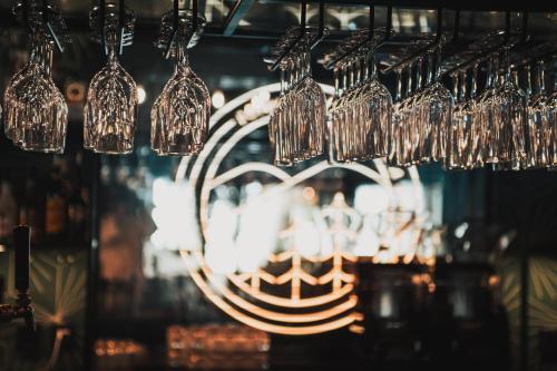 a bunch of wine glasses hanging from a ceiling at Hotell Lappland in Lycksele