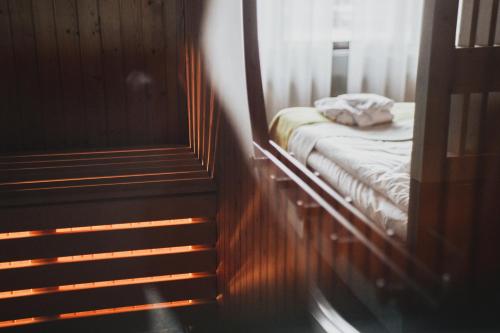 a small bed in a room next to a staircase at Hotell Lappland in Lycksele