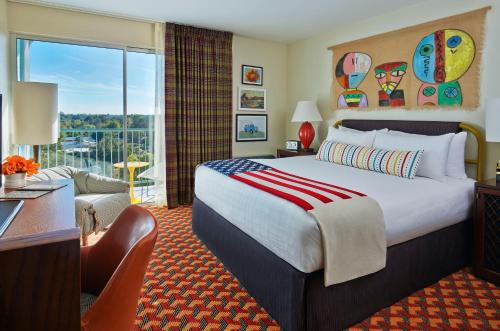 a hotel room with a large bed and a balcony at Graduate Tempe in Tempe