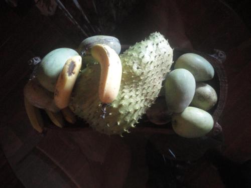 a plate of food with bananas and bread and apples at Rohotu Fare in Bora Bora
