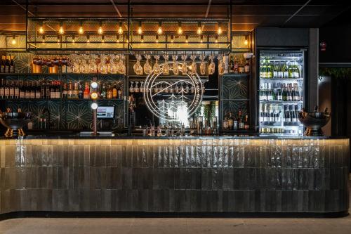 a bar with a lot of bottles of alcohol at Hotell Lappland in Lycksele