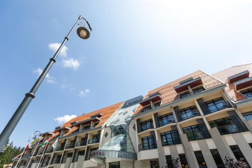 a building with a street light in front of it at HOTEL CRYSTAL WELLNESS & SPA superior in Sovata