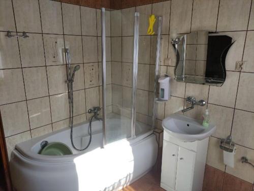 a bathroom with a shower and a toilet and a sink at Pod Modrzewiem ul Modrzewiowa 7 in Milicz