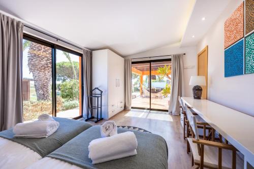 a bedroom with a bed and a counter with a counter at Unique Villa -1 km to Beach, private Natural pool, Tennis Court & Jumping Mat in Sagres