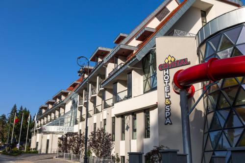 a building with a sign on the side of it at HOTEL CRYSTAL WELLNESS & SPA superior in Sovata
