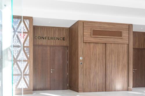 a pair of wooden doors in a building at HOTEL CRYSTAL WELLNESS & SPA superior in Sovata