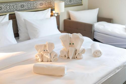 a hotel room with towels on a bed at HOTEL CRYSTAL WELLNESS & SPA superior in Sovata