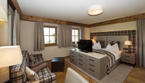 a bedroom with a bed and a living room at Chalet Winterbauer in Flachau