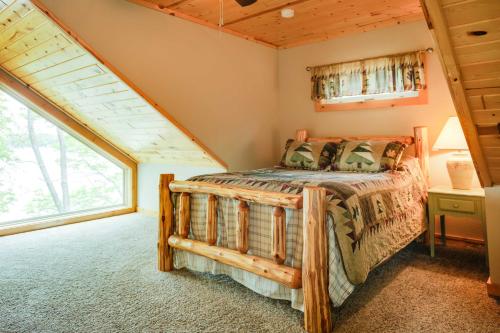 a bedroom with a bed and a large window at Lakefront Wisconsin Cabin Dock, Walk to Beach! 