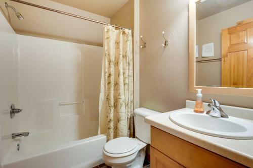 a bathroom with a sink and a toilet and a mirror at Lakefront Wisconsin Getaway with Kayak and Boat Dock! 