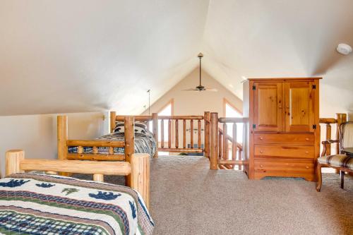 a bedroom with two beds and a wooden staircase at Lakefront Wisconsin Getaway with Kayak and Boat Dock! 