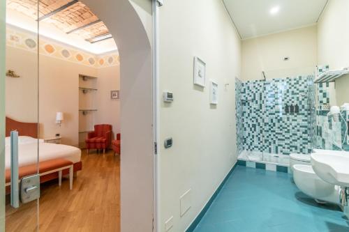 a bathroom with a bed and a shower and a sink at Casa Isolani Luxury Rooms Piazza Maggiore in Bologna