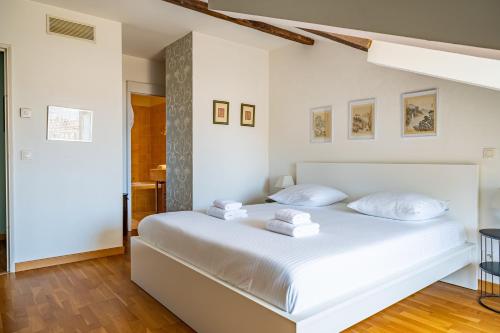 a bedroom with a white bed with white pillows at The Good Mother - Vue sur Notre Dame de la Garde in Marseille