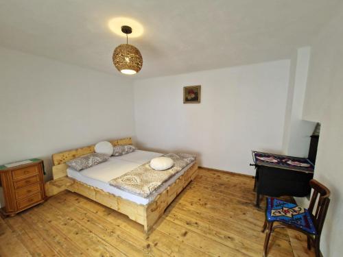 a bedroom with a bed and a table and a lamp at FLORESTI HOUSE 21 in Roandola