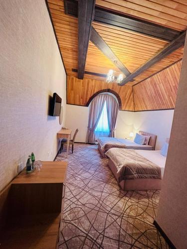 a bedroom with a bed and a table in a room at Cinema Boutique Hotel in Ganja