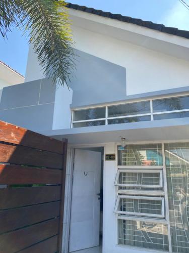 a white house with a white door and a window at Fullhouse in Mataram