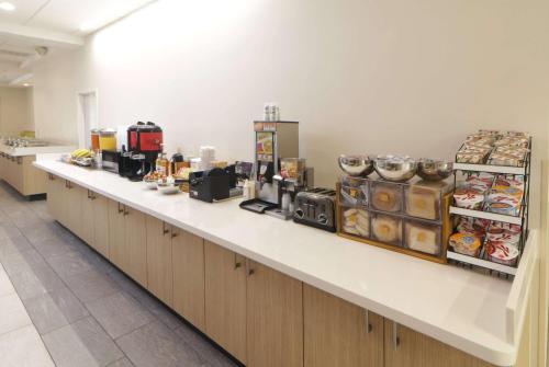a long counter in a kitchen with food on it at Wyndham Garden McAllen at La Plaza Mall in McAllen