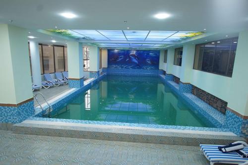 a pool in a hotel room with a swimming pool at Best Western Premier Dynasty in Addis Ababa