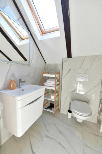 a bathroom with a white sink and a toilet at Vila Marija in Rastovača
