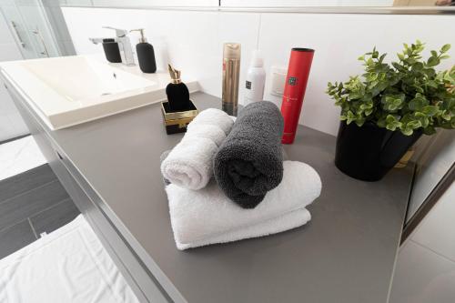 a bathroom with towels on a counter with a sink at Vila Maria in Vinkovci