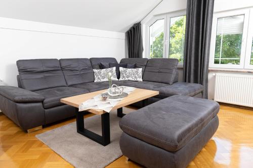 a living room with a couch and a table at Vila Maria in Vinkovci