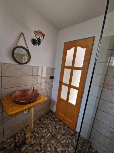 a bathroom with a wooden sink and a mirror at FLORESTI HOUSE 21 in Roandola