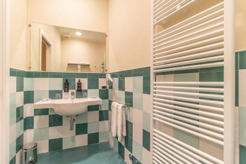 a bathroom with a sink and a mirror at Casa Isolani Luxury Rooms Piazza Maggiore 1 in Bologna