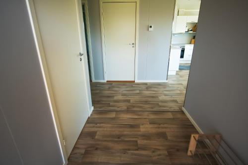 a hallway with wood flooring in a house at Senja Fjordhotell and Apartments in Stonglandseidet