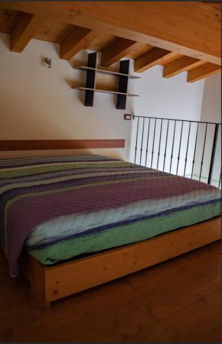 a bedroom with a bed with a cross on the wall at Casale el galet in Moniga