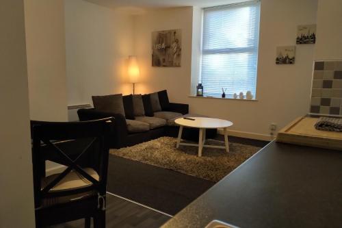 a living room with a couch and a table at Urban Chic Suite - Simple2let Serviced Apartments in Halifax