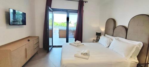 um quarto com uma cama grande com duas toalhas em Marisabella Suite Spa 5 em Bari