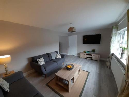 a living room with a couch and a coffee table at Stylish 4 Bed, newly renovated home in Nottingham in Nottingham