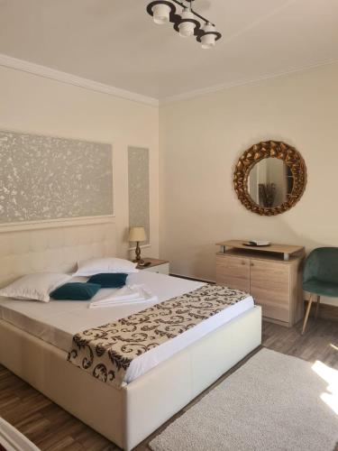 a bedroom with a large bed and a mirror at Casa Dadi in Constanţa