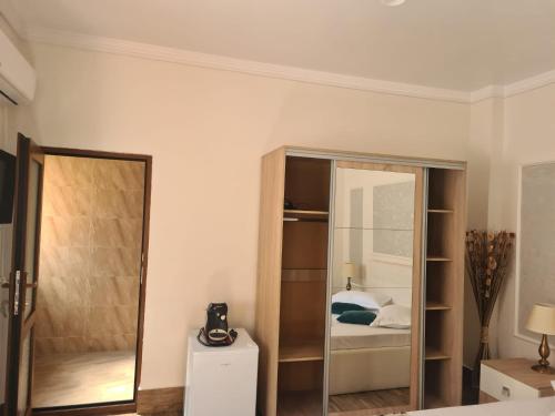 a bedroom with a mirror and a bed at Casa Dadi in Constanţa