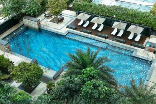 an overhead view of a swimming pool with chaise lounge chairs at The Ritz-Carlton, Shenzhen in Shenzhen