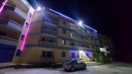 a car parked in front of a building at night at Anglo Chalets - Ageeba beach in Marsa Matruh