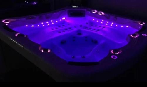 a purple table with lights on top of it at Bordeneuve Chalet de Gaïa in Sonnac-sur-lʼHers