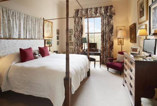 a bedroom with a large white bed and a desk at The Victorian Wing in Shifnal