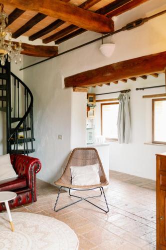a living room with a rattan chair and a couch at Agriturismo Quarantallina in Buonconvento