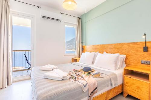 a bedroom with a bed with a large window at Mavilim Hotel in Kas